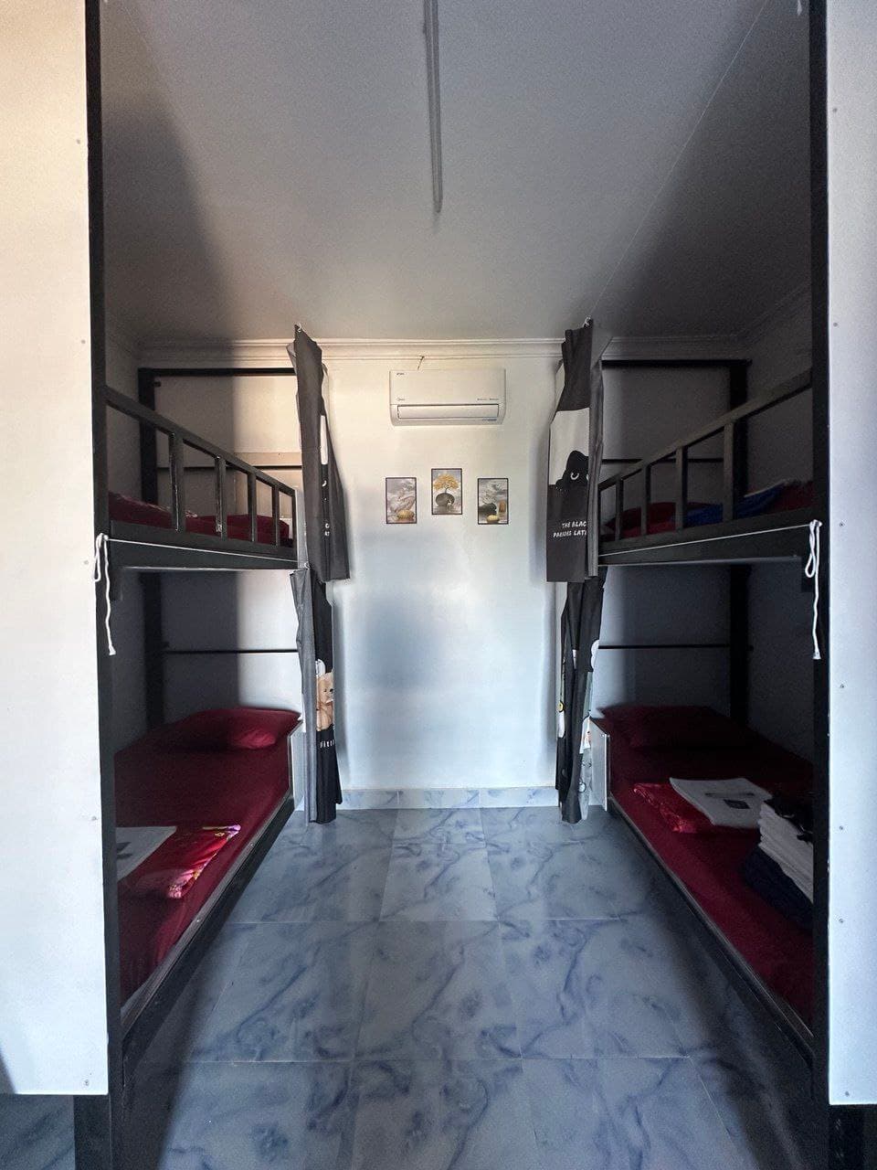 8-bed dormitory with privacy curtains